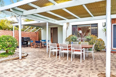 The front patio boasts plenty of space for the whole group to enjoy alfresco dining with two outdoor settings. 