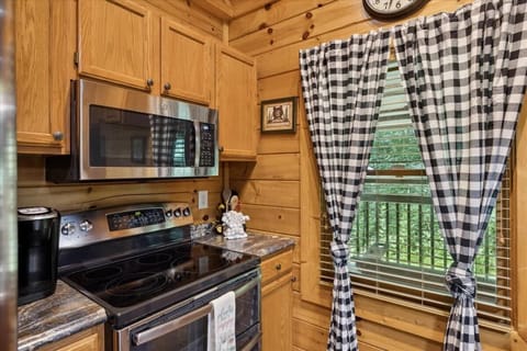 Whip up meals with style in this charming wood-finished kitchen with modern appliances!