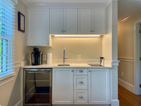 Small kitchen with undercounter refrigeration and two burner countertop cooktop