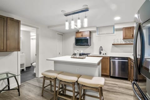 Barstool seating for 3 is available at the kitchen island.