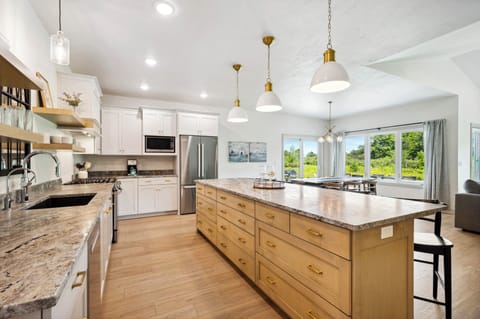 Kitchen overlooks the dining room table and has view of the Orchard!