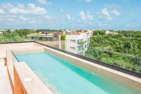 Rooftop pool with views overlooking Tulum