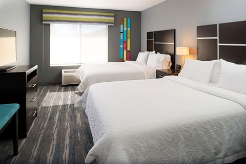 Wake up refreshed in a bright room with two plush beds.