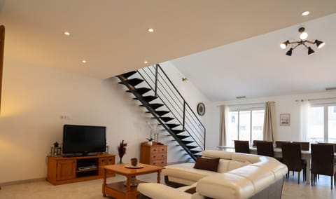 Large air-conditioned lounge opening onto the kitchen and terrace