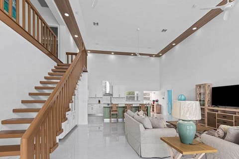 Open concept kitchen, dining, and living room flooded with natural light.