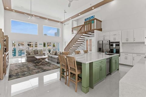 Open concept kitchen, dining, and living room flooded with natural light.