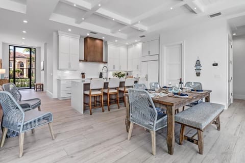 Open layout with kitchen island and dining area to comfortably seat 10 to 11. 