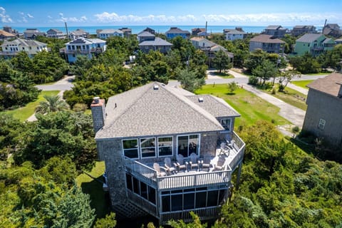 Front Exterior: Welcoming exterior of Mad Hatteras surrounded by natural coastal landscaping.