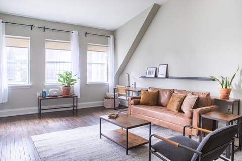 Spacious living area with abundant natural light, dedicated workspace, and dining/work table