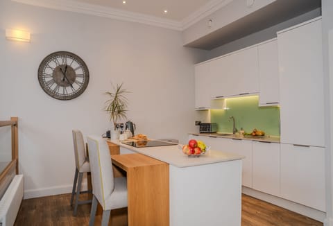 Electric oven, induction hob and a sit-up island seating two guests in the kitchen area