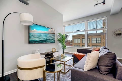 Living area with sofa, table and TV