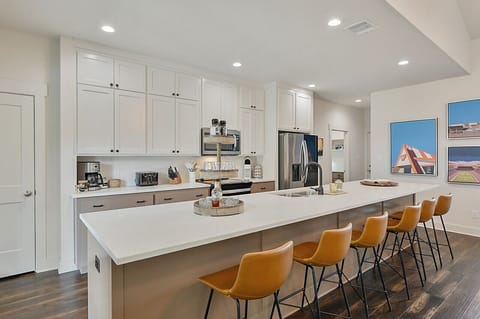 Abundant bar seating around the kitchen island encourages casual dining and socializing in the heart of the home.