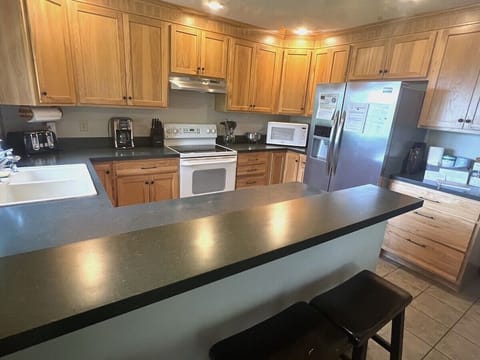 Cozy kitchen that is well stocked and offers a large sink and plenty of storage