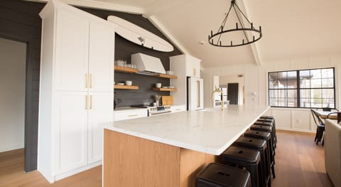 Kitchen has cafe appliances with double oven and large island with seating for 8