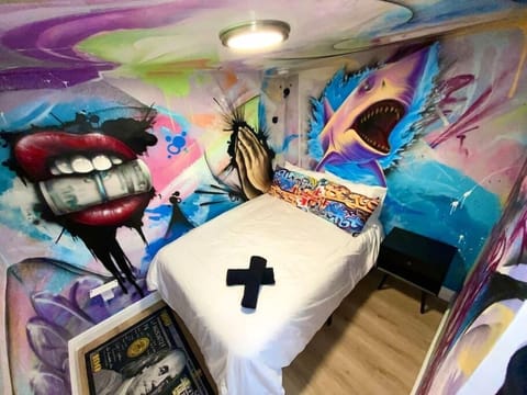 Unit 2 unveils a vibrant sanctuary, a canvas of colors embracing unique hand-painted murals—Money Mouth,' 'Gold-tooth Shark,' 'Pray for Me.' A stay like no other, immersed in Wynwood's eclectic spirit. Every wall tells a story in the hues of Miami. 