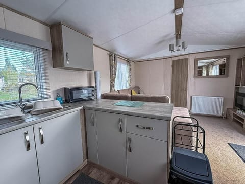Bright and airy kitchen flowing into cozy living area