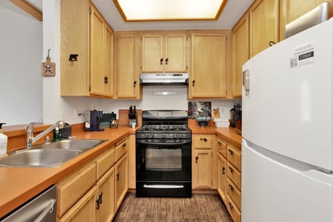 Fully equipped cabin kitchen with ample cabinetry, stove, fridge, microwave, and coffee maker—perfect for cooking meals, morning coffee, and feeling right at home on your stay.