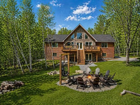 Luxury Log Cabin Exterior at Day with Fire Pit