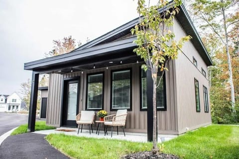 This is the front of the tiny home with two seats to sit out on and enjoy the peaceful neighborhood. There are stringed lights that light up at night as well!