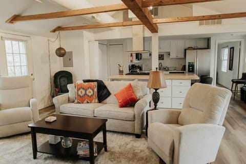 Relax and unwind in our thoughtfully arranged living room, where comfortable, well-designed couches and pillows await your enjoyment.