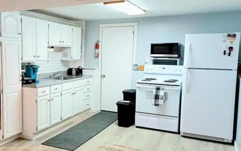 Plenty of space with micowave, stove, refrigerator and freezer, door to backyard