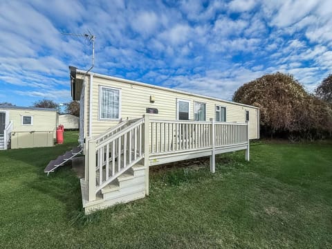 Cozy deck retreat with spacious lawn for outdoor fun