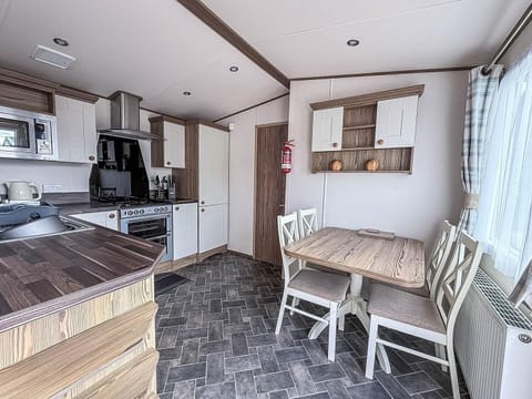Cozy dining nook with bright natural light and modern kitchen