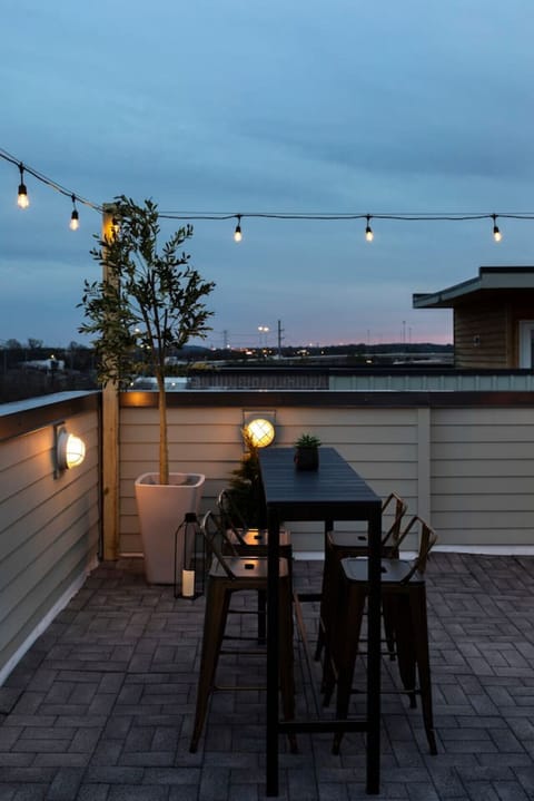 Private rooftop dining with skyline backdrop.