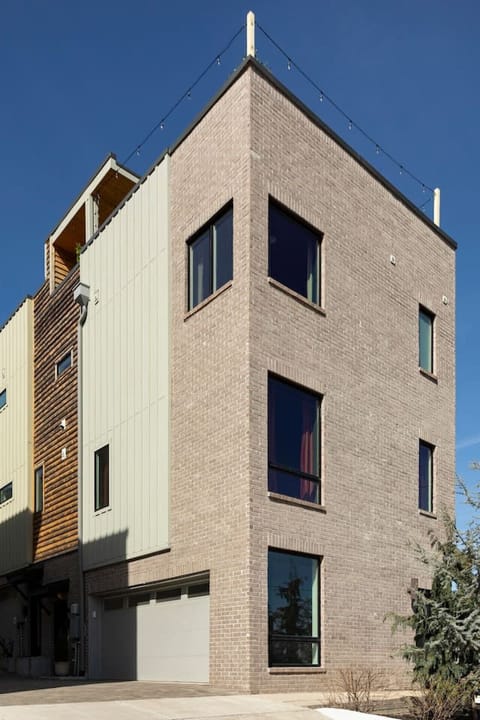 Modern 4-level home with garage and rooftop patio.