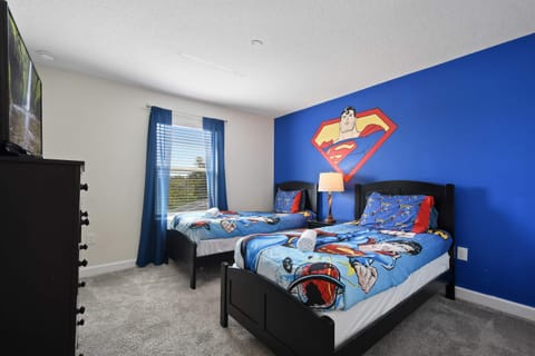 Relax in comfort in our Superman Themed room with two twin beds, offering you a convenient and inviting space to make the most of your stay.
