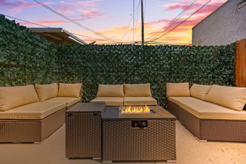 Grass Wall Patiio with Outdoor furniture and fire pit