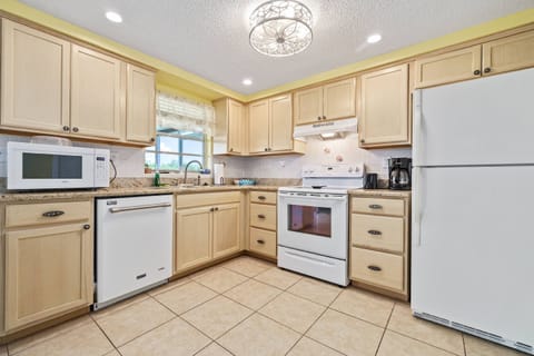Kitchen with dishwasher, microwave, stove, coffee pot, air fryer