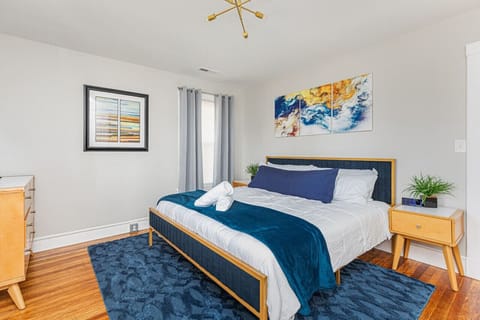 Indulge in luxury in our primary `blue suede` bedroom, featuring a regal king bed and a flat-screen TV with Roku for your entertainment needs.