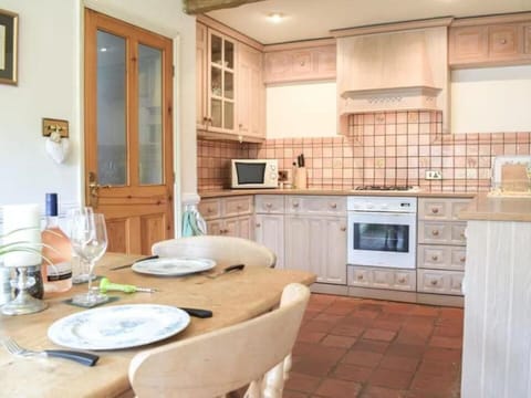 Fully fitted kitchen, with brass light fittings, door furniture and dining area 