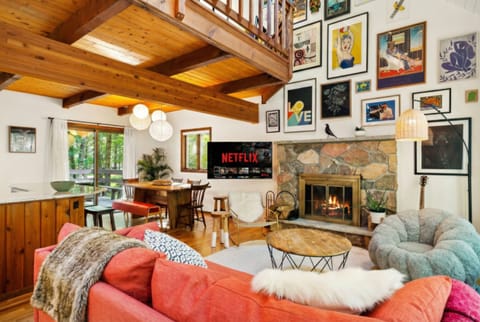 Living area with couch, comfy chairs, and gallery art wall