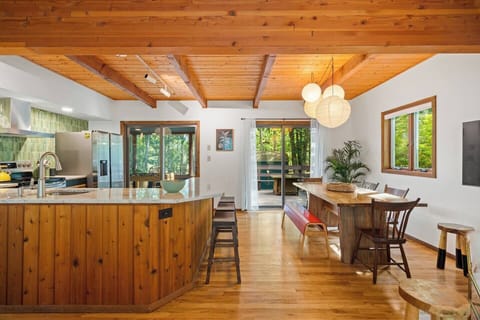 Dining room and kitchen w/view of screened porch and patio/firepit table