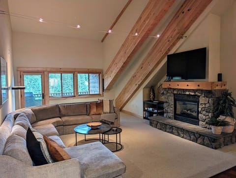Living room area with gas fireplace and smart TV.