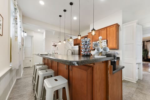 Kitchen island w/ extra storage, 2nd stairway & patio w/ gas BBQ grill.