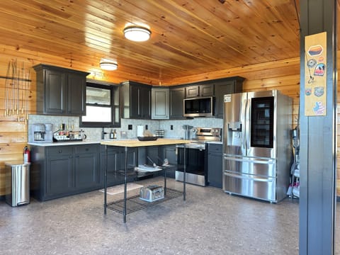 Newly renovated kitchen with new quartz counters, backsplash, and black sink.