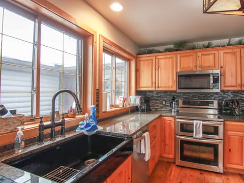 Chef's kitchen with high end stainless appliances and fully stocked cupboards