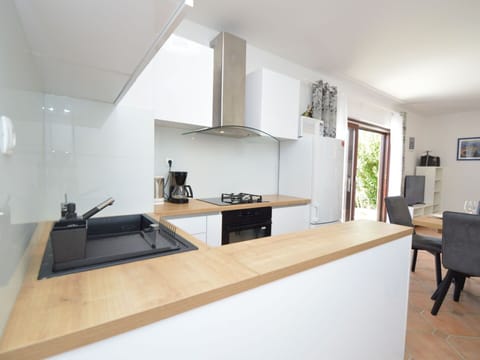 Furniture, Countertop, Cabinetry, Table, Interior Design, Wood, Kitchen, Flooring, Floor, Kitchen Stove