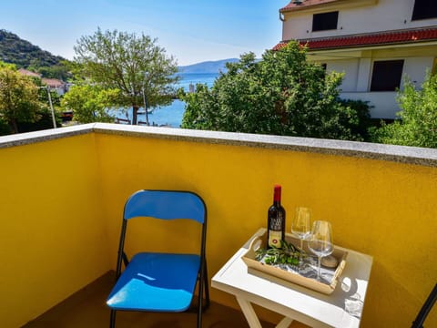 Sky, Table, Property, Building, Window, Bottle, Plant, Tableware, Tree, Chair