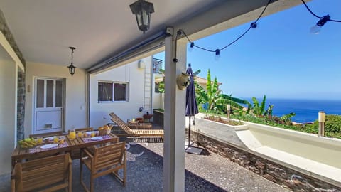 A cozy patio retreat, complete with a breathtaking panoramic ocean view that invites relaxation and serenity. #oceanview #breakfast #outdoor #furniture