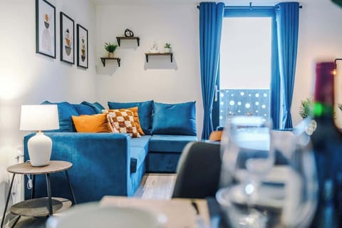 The open-plan living room and dining area benefit from a 50-inch Smart TV, a 6-seater dining table, plenty of space to sit down in the evenings, a double sofa bed and a sizable balcony.
