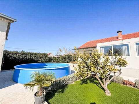 Blue, Swimming Pool, Garden, Resort, Outdoor Furniture, Leisure, Backyard, Landscaping, Shade, Yard