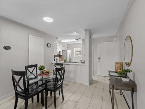 Dining room for 4 people with kitchen, bathroom and front entrance view