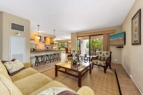 Gather in this inviting space that flows seamlessly to the kitchen and patio