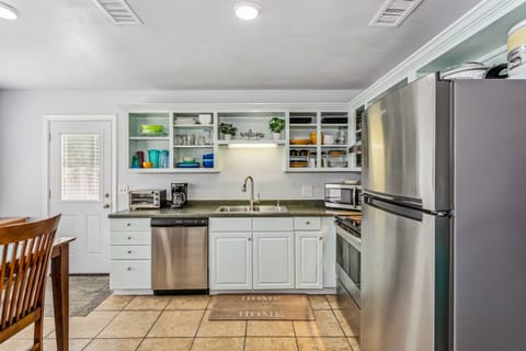 Fully stocked kitchen with tile floors