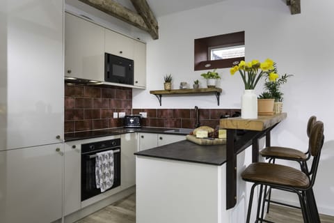 Kitchen area with a sit-up island seating two guests