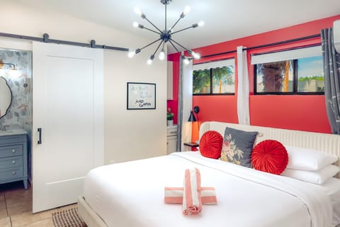 Vibrant King Oasis: Bold red accents, modern flair, and a plush king bed make this your stylish Palm Springs escape.